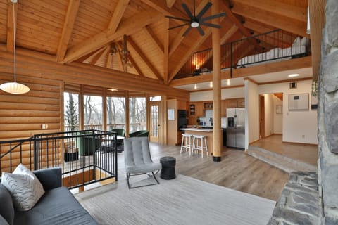 First Floor living area. Couches, chairs, a full kitchen, walkout deck and views
