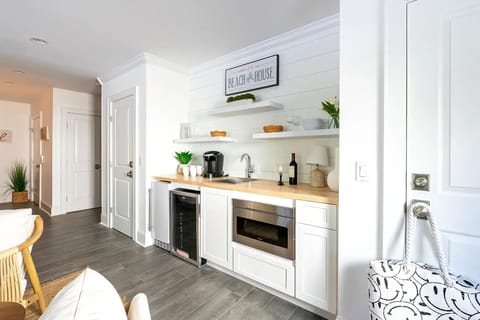 1st Floor Living Room including large screen TV, Beverage Refrigerator, Ice Maker, Microwave, and sink.  Also has a full bathroom off the side for easy access from the pool.