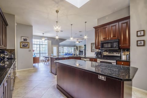 Large island with a built-in wine fridge makes food prep or buffet serving easy