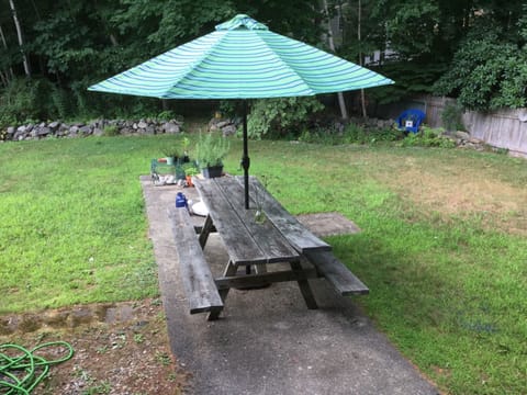 Back patio with grill, picnic table and yard games 