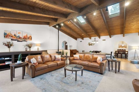 Spacious combined living and dining room with vaulted ceiling for gathering at the end of the day