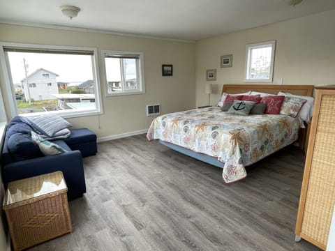 Large master bedroom with king sized bed; corner couch / trundle for a child.