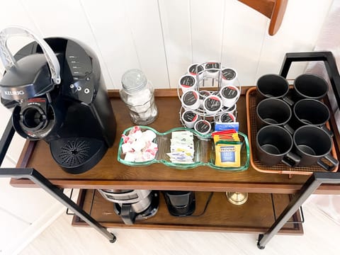 Coffee bar with keurig, pods, cream, sugar, tea, and mints. 
Drip coffee maker
