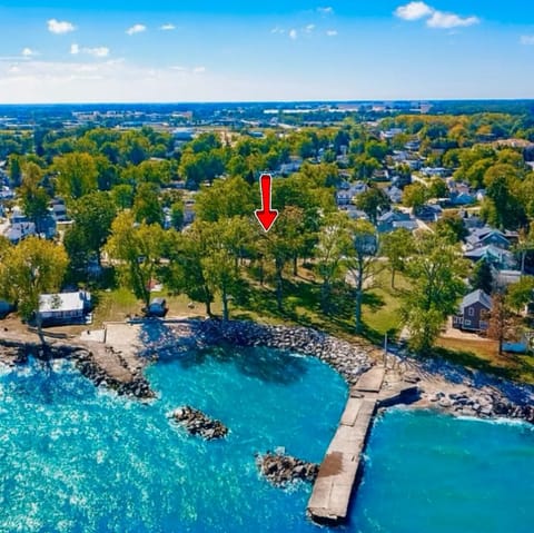 A stunning aerial view of the private beach and shoreline where The Castle sits. Enjoy peaceful lake access, open green space, and beautiful scenery just steps from your stay.

