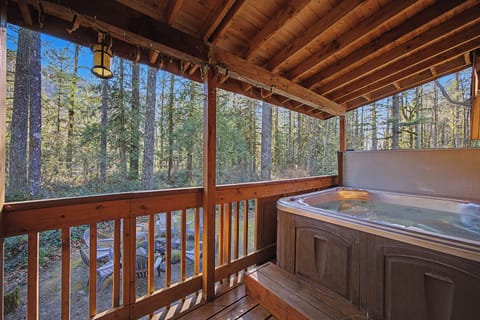 Soak your worries away in this private hot tub, surrounded by towering forest views on your secluded deck retreat.