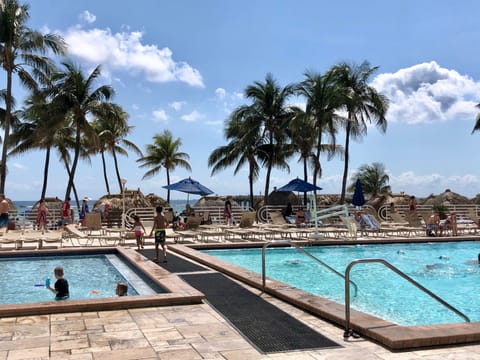 Large heated swimming pool and poolside loungers