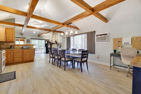 Modern dining space seats 8under high ceilings and views to the outdoors 