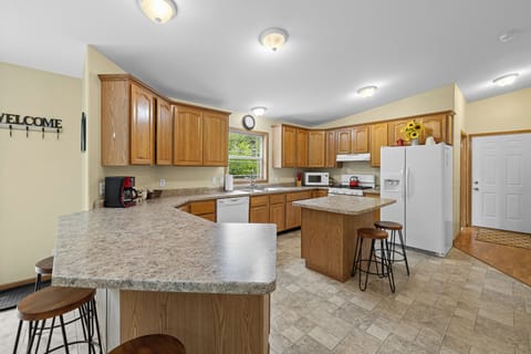 Large fully equipped kitchen with extra seating.