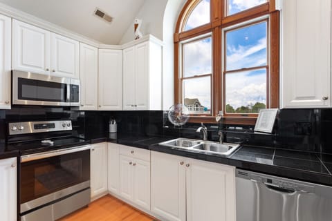 A modern kitchen comes fully stocked with everything you need to cook delicious meals in your own home on those nights you don't feel like venturing out, including a Keurig for early morning coffee.