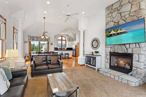 Relax in the spacious Living Area with a fireplace, flat-screen TV, and deck access. (Please Note: Fireplace is not for guest use)