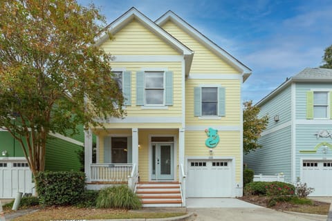 Front Exterior: Charming townhouse with bright coastal décor and an easy-to-spot mermaid accent, welcoming you to your OBX getaway.