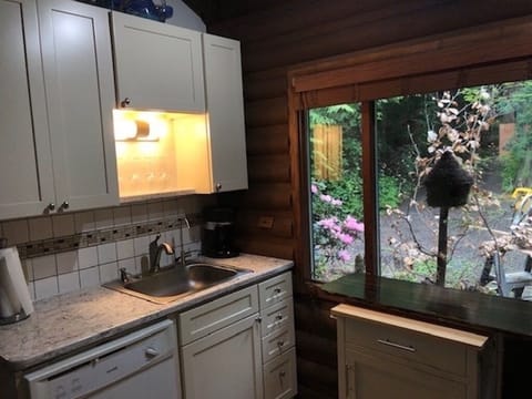 Custom cabinets, quartz countertop, filtered H2O, rolling cutting board cabinet.