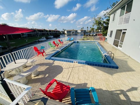 Pool area overlooking the canal.  Plenty of seating and an umbrella for shade.