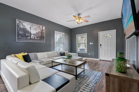 Spacious beautiful living room with a beautiful L-Shaped couch where you and your family and friends can bond and relax. 