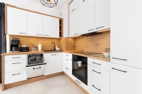  A functional kitchen with wooden details, modern appliances, and an organized layout.