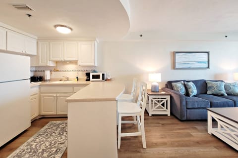 Kitchen features a full size refrigerator w/ ice-maker, 2 burner stove (no oven), coffee pot, microwave, toaster, cookware, dishes, utensils, etc.