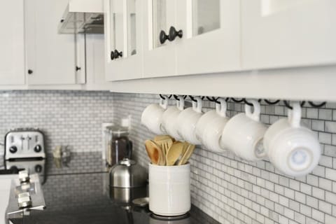 Kitchen is stocked w/ dishes, silverware, cooking utensils and pots/pans. 