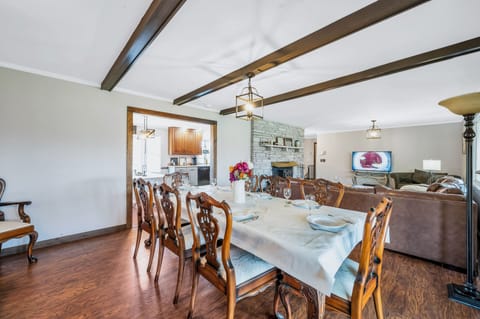 Dining table. Opening leads to kitchen area with a second table for dining