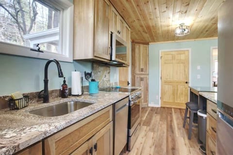 The kitchen has granite countertops, all new stainless appliances, and gorgeous cabinetry.