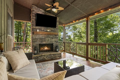 Main level back deck with wood burning fireplace and big screen smart tv