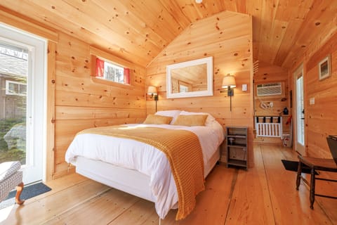 The inviting queen-size bed is dressed in soft, high-quality linens