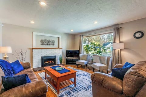 living room area next to the front door with fireplace and tv