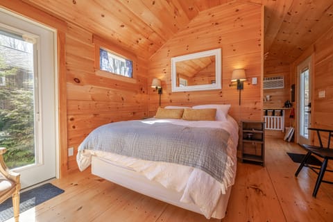 The inviting queen-size bed is dressed in soft, high-quality linens