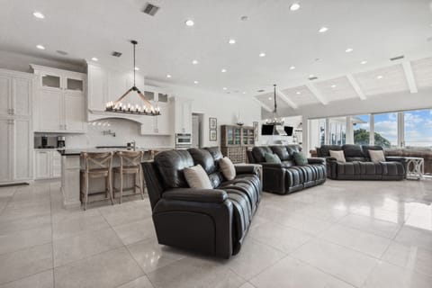 Massive Great Room with Oversized Island, Ample Seating, Flat Screen TV, Gas Log Fireplace, and Wall to Wall Doors with Oceanfront Views