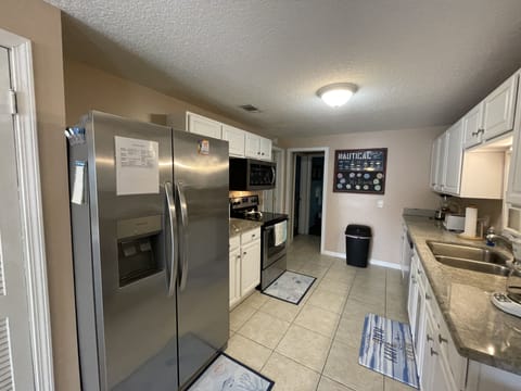 Kitchen- Full sized Fridge, Glass Top Range and Microwave.
