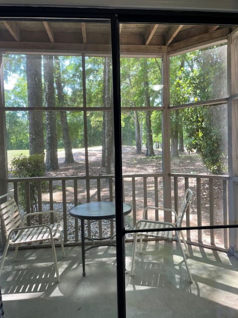 Private screened porch off front bedroom with golf green view
