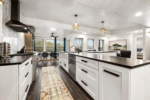 Directly behind this area, you'll see our kitchen as well as THREE separate dining areas.