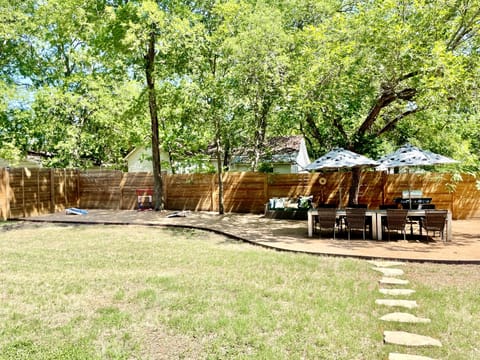 Large backyard with dining for 8.  Enjoy a game of corn hole and ladder ball.