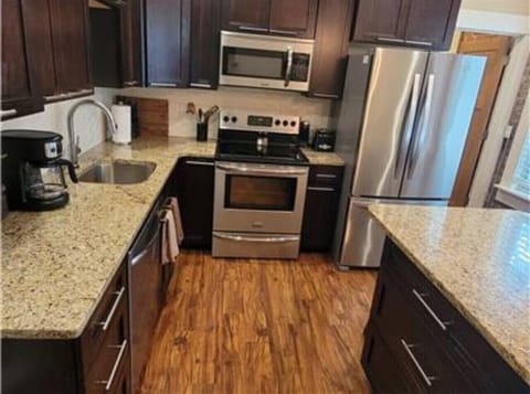 The well-equipped kitchen provides a seamless blend of form and function, with top-of-the-line appliances, ample countertop space, and an array of kitchen essentials.