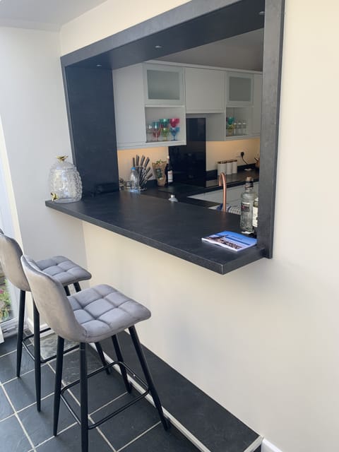 Bespoke Bar area with Bar stools looking towards the kitchen