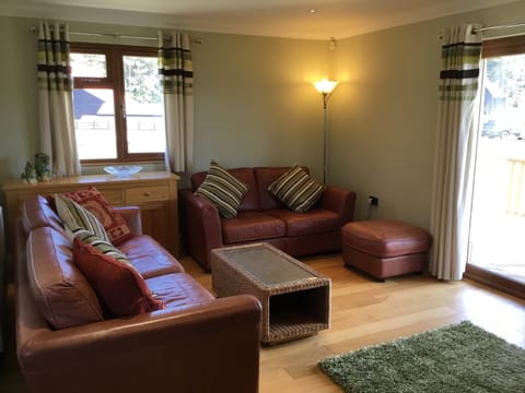 Comfortable leather sofas with view and access to the covered veranda.