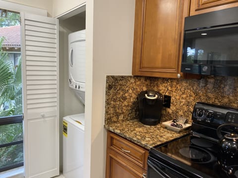 Keurig coffee machine provided and laundry located in kitchen
