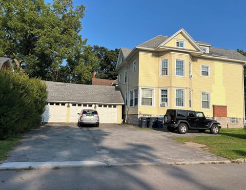 View of parking lot, two vehicles are shown for scale
