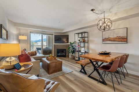 Living room with an electric fireplace, Smart TV with cable, board games, a Wii-U (with games), cozy seating options and walkout access to the balcony.