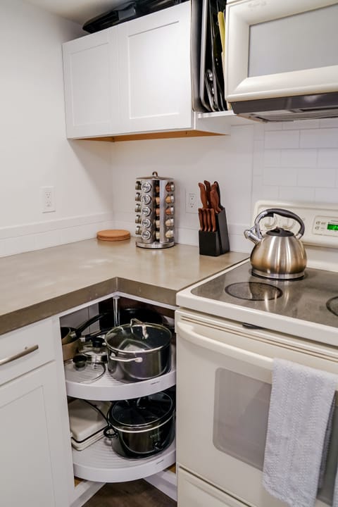 Fully stocked kitchen with spices, basic supplies.