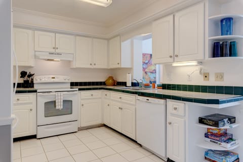 Full stocked kitchen with new appliances and utensils and lots of glassware.