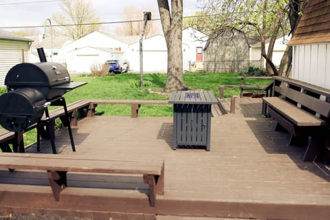 Outdoor fire pit table with deluxe charcoal grill.