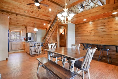 Additional medium dining table in Hearth room, with access to screened deck.
