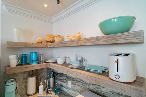 Custom hand made driftwood shelves show everything you need to have a wonderful breakfast, lunch or dinner in your Marisand suite. 