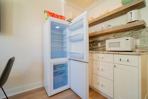 Classic retro refrigerator & freezer will come in handy for longer stays on Palm Beach Island. Pull out trash on the right.