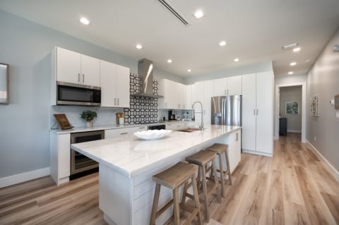 Fully stocked kitchen with utensils and appliances