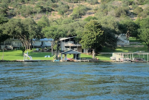 House and boat dock in center, view from across cove.