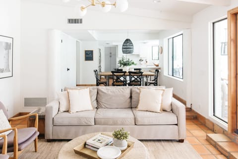 View from the main living past the comfy couch to the dining room and kitchen.