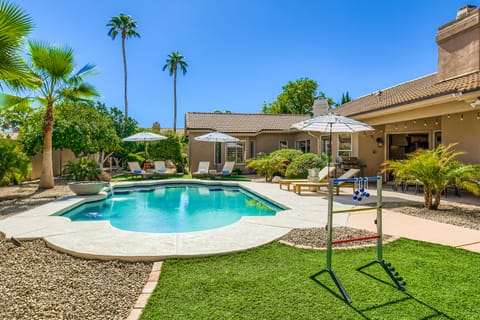 A refreshing pool surrounded by palms and fruit trees.