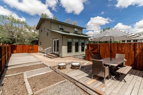 Fenced in outdoor area with dining furniture