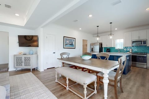 The wood crafted dining table comfortably seats 6 people, and the kitchen island provides additional seating for 4.